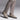 A person stands against a neutral background wearing light brown plaid trousers and Anthony Veers Arden Chukka Boot in Rustic Clay Grey Suede, featuring a durable Vibram rubber outsole.