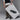 A person in a black vest, white shirt, and beige pants holds a large poster featuring Anthony Veers Mariner Fisherman Sandal in Obsidian Black. The poster reads New Arrival 23.