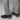 A person stands on a plain light gray surface wearing light beige plaid dress pants and Anthony Veer Bedford Chukka boots in Tobacco Velvet Brown, featuring dark brown Italian suede, light brown soles, and Goodyear welt construction.