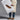 A person in a beige trench coat, blue jeans, and brown chukka boots holds an oversized poster featuring the Anthony Veer Heritage Moc Chukka // Golden Fawn Brown Suede with New Arrival 25’ text.
